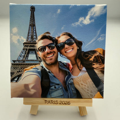 Canvas print of a couple in front of the Eiffel Tower with 'Paris 2026' text.